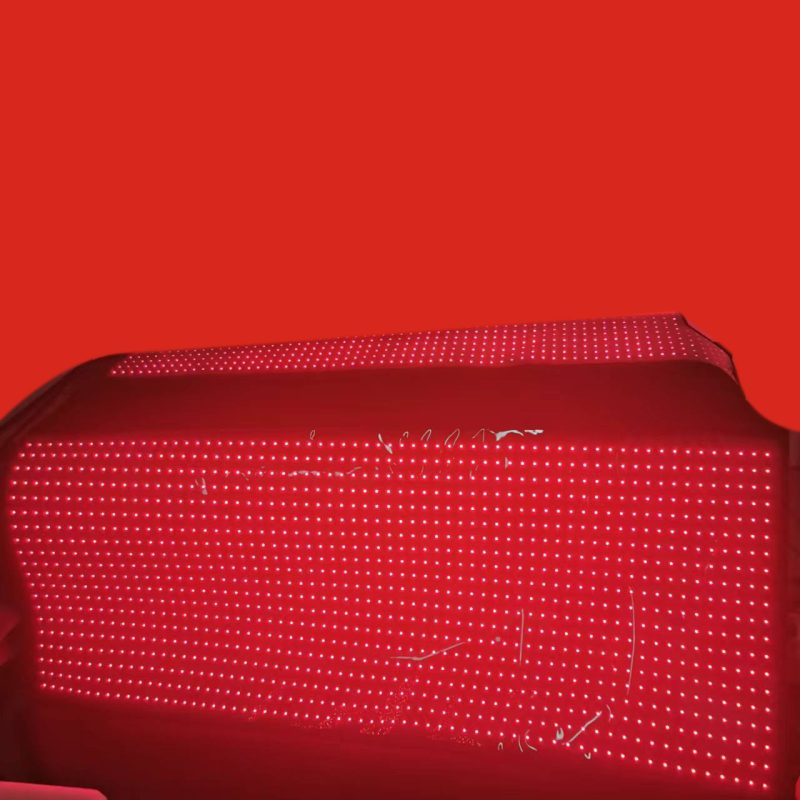 Person using red light therapy mat.